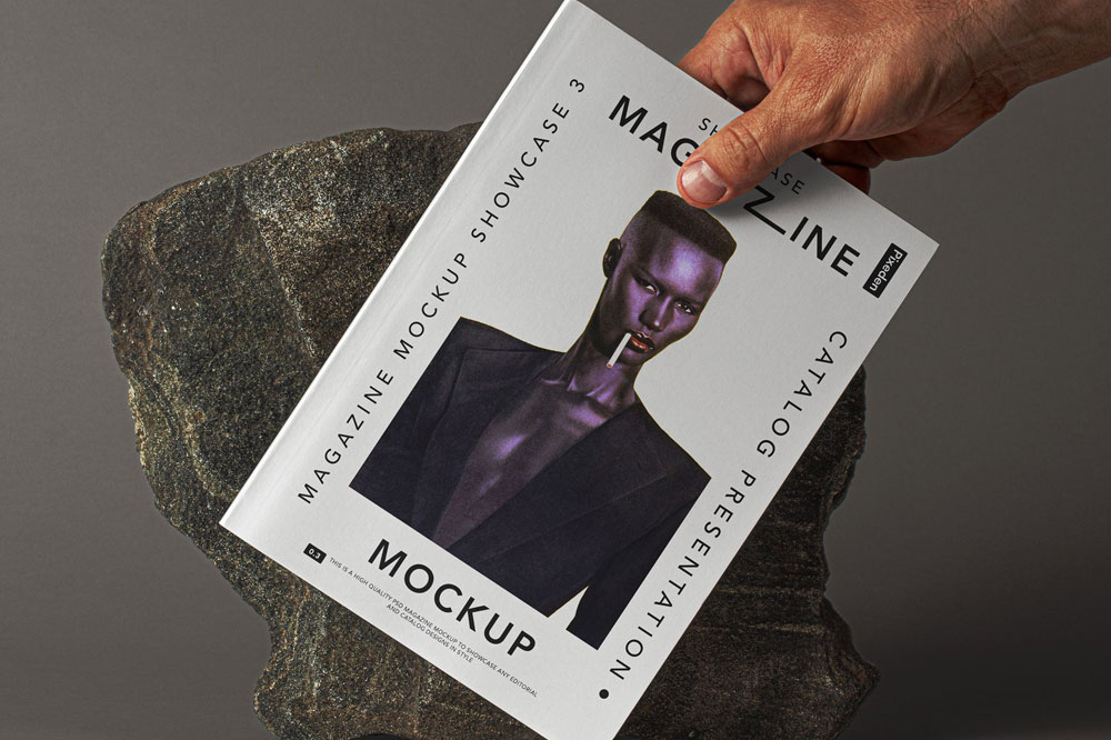 Free Hand Holding Magazine Mockup PSD