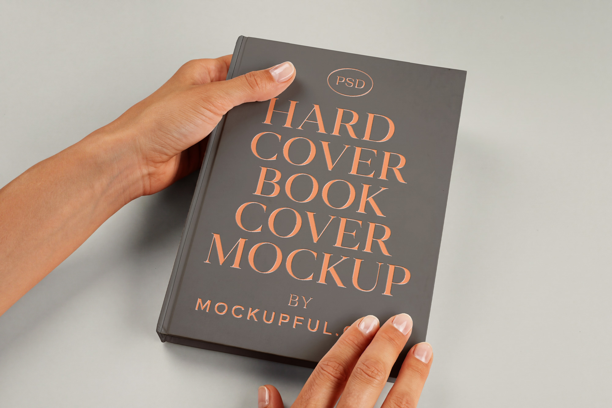 Free Hand Holding Hardcover Book Mockup