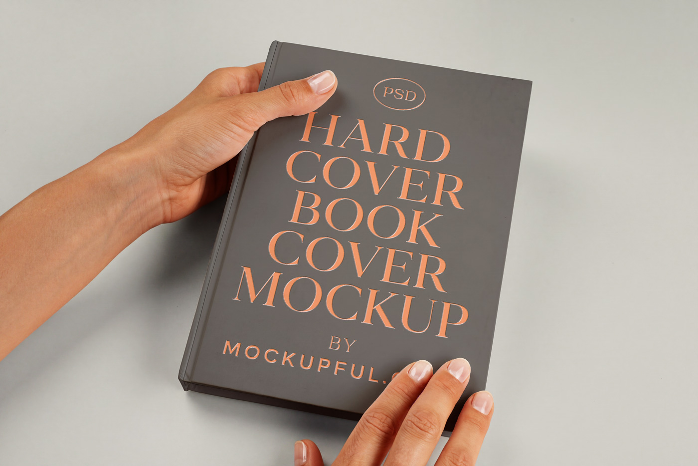 Free Hand Holding Hardcover Book Mockup